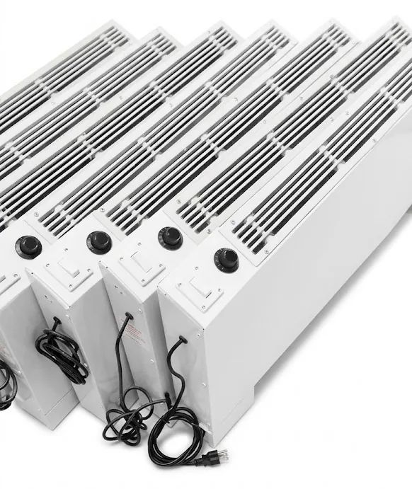 Electric heaters in a row, with control knobs and power cords